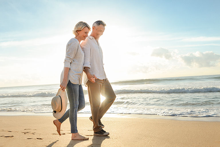 Couple Walking On The Beac